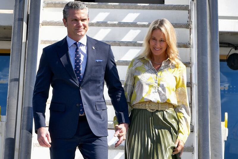 US Secretary of Defense Pete Hegseth (L) and his wife Jennifer Rauchet (R) arrive at Las Americas International Airport in Punta Caucedo, near Santo Domingo, Dominican Republic on November 26, 2025.