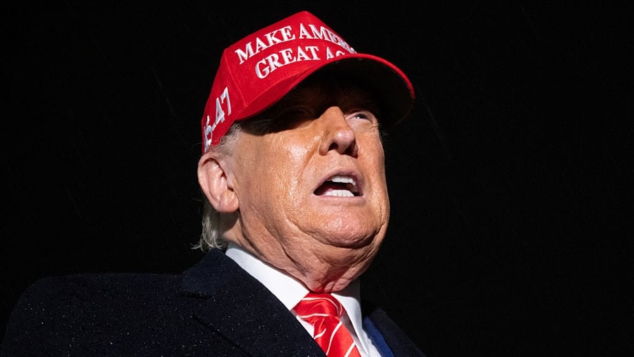 US President Donald Trump speaks to the press in the rain after landing on Air Force One at Joint Base Andrews in Maryland, May 30, 2025, after traveling to Pennsylvania to visit a US Steel plant.