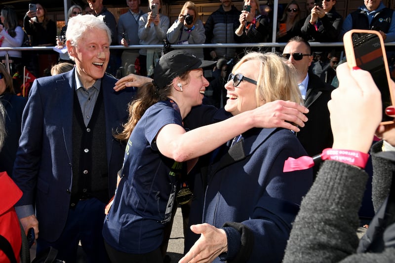 Former US President Bill Clinton greets Chelsea Clinton at the finish line during the 2025 TCS New York City Marathon