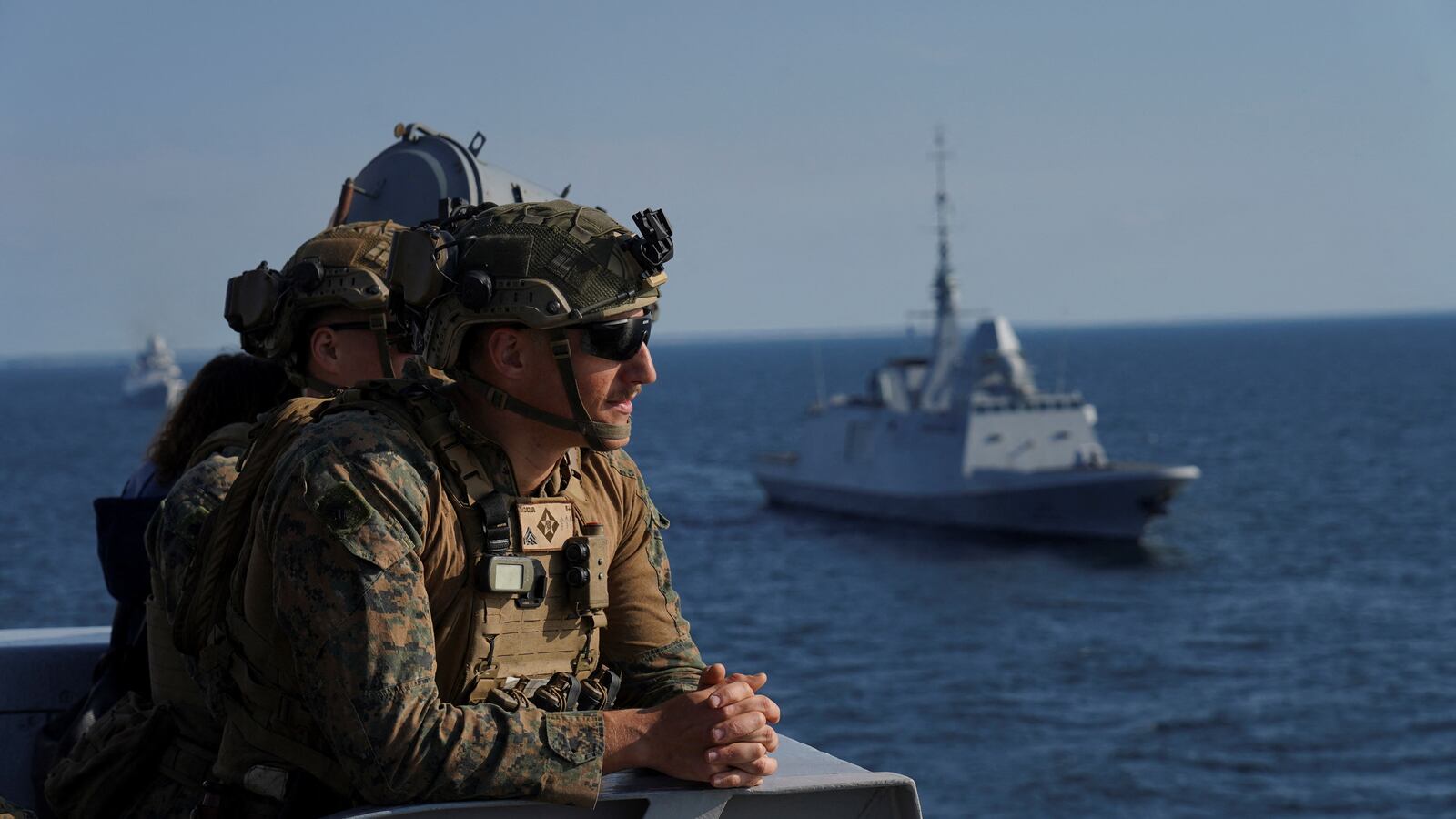 U.S. Marine servicemen look at navy ships