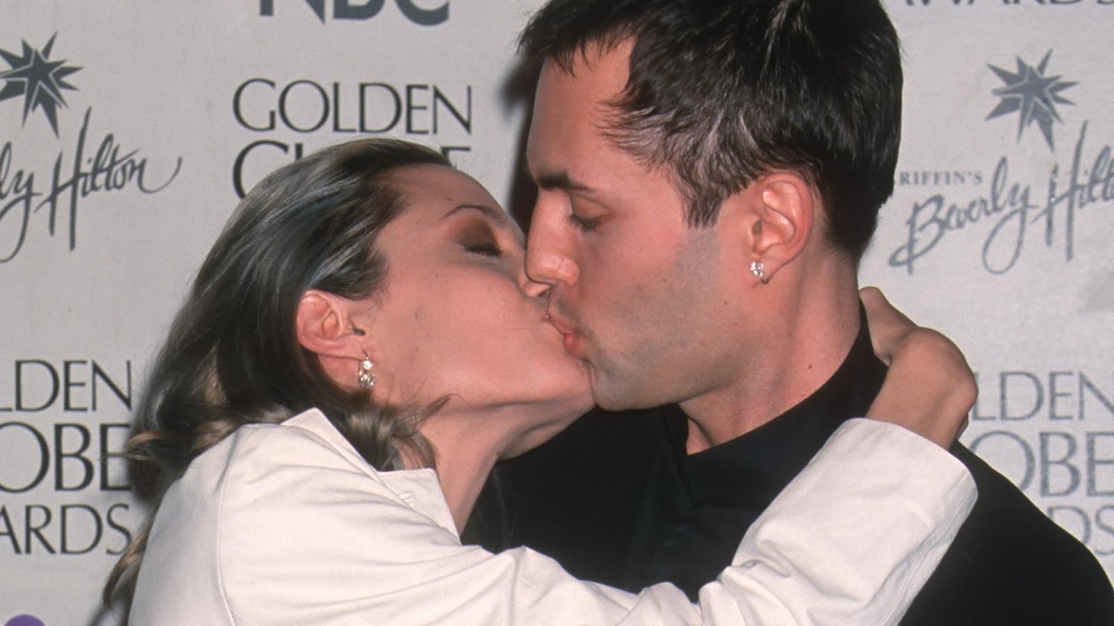 Sibling actors Angelina Jolie and James Haven kiss as they attend the 57th annual Golden Globe Awards in 2000.
