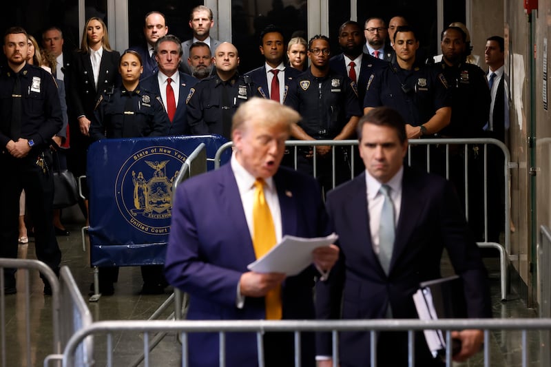 North Dakota Governor Doug Burgum, former Presidential candidate Vivek Ramaswamy, Rep. Byron Donalds (R-FL) listen as former U.S. President Donald Trump speaks to the media.