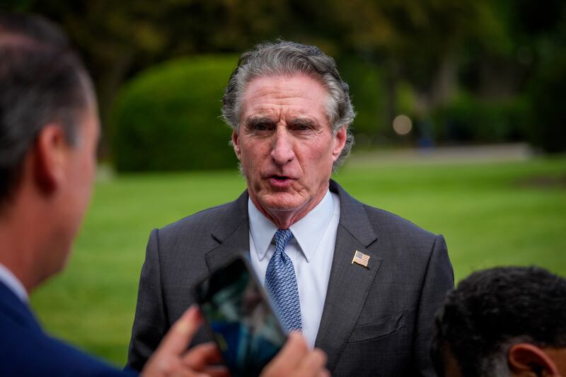 U.S. Interior Secretary Doug Burgum walks to a television interview on the North Lawn of the White House on August 12, 2025 in Washington,
