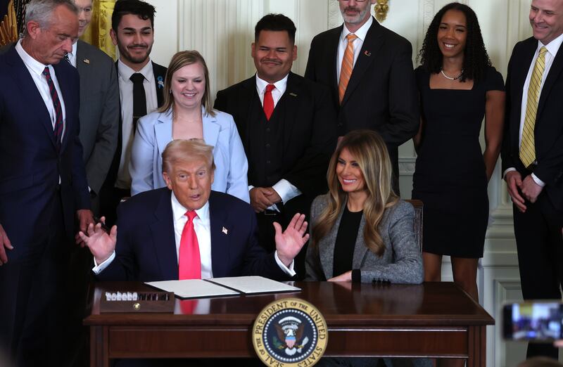 WASHINGTON, DC - NOVEMBER 13: U.S. President Donald Trump, joined by first lady Melania Trump, members of his administration and foster care advocates, speaks before signing the "Fostering the Future" executive order in the East Room of the White House on November 13, 2025 in Washington, DC. The executive order, championed by first lady Melania Trump, works to expand opportunities for education, career development, housing and other resources for youth transitioning from foster care to adulthood. (Photo by Anna Moneymaker/Getty Images)
