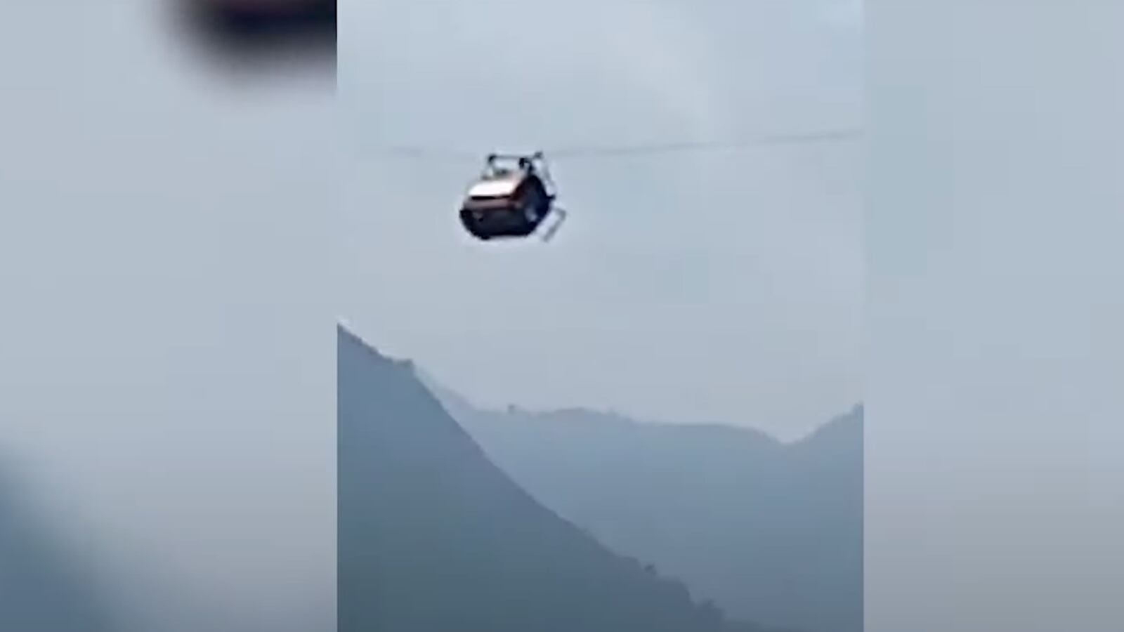 A cable car dangles 900 feet above a ravine in Pakistan.