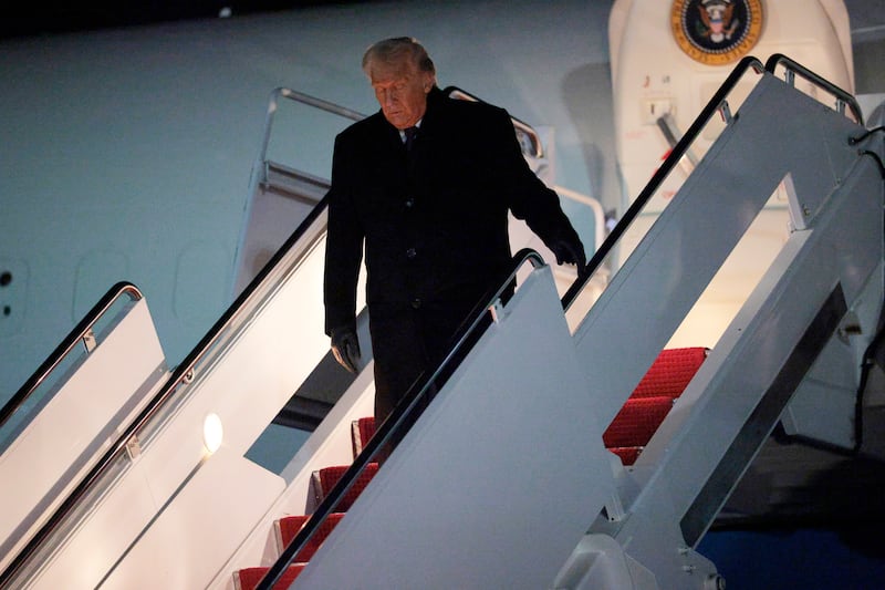 President Donald Trump steps down from Air Force One as he returns to Washington from the World Economic Forum on January 22, 2026 at Joint Base Andrews, Maryland.
