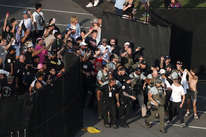 MMA fighter Sean Strickland is escorted out of the UFC Freedom 250 Fan Fest on The Ellipse by U.S. Secret Service and other law enforcement ahead of the UFC Freedom 250 fight on the South Lawn of the White House, in Washington, D.C., U.S., June 14, 2026.      Kevin Dietsch/Pool via REUTERS