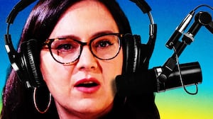 Bari Weiss wearing podcast headphones in front of a podcast mic