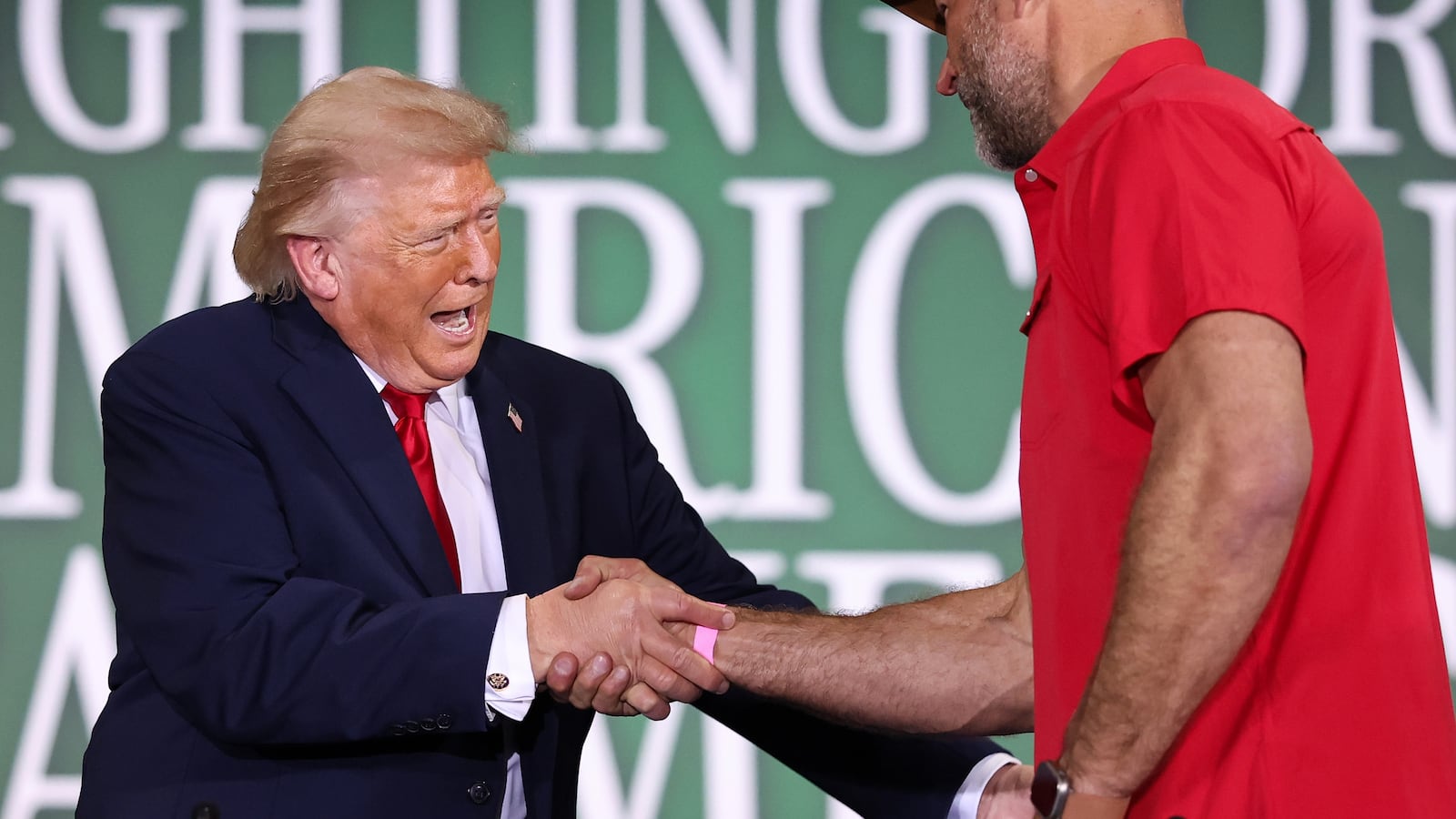 U.S. President Donald Trump shakes hands with Hall of Fame Farms owner Joe Thomas (R) as he arrives to a roundtable on agriculture at Custer Farms on June 05, 2026 in Chippewa Falls, Wisconsin.