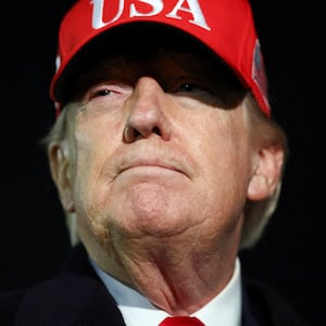 U.S. President Donald Trump looks on after disembarking Air Force One as he arrives at Joint Base Andrews in Maryland, U.S., April 12, 2026.  REUTERS/Kevin Lamarque