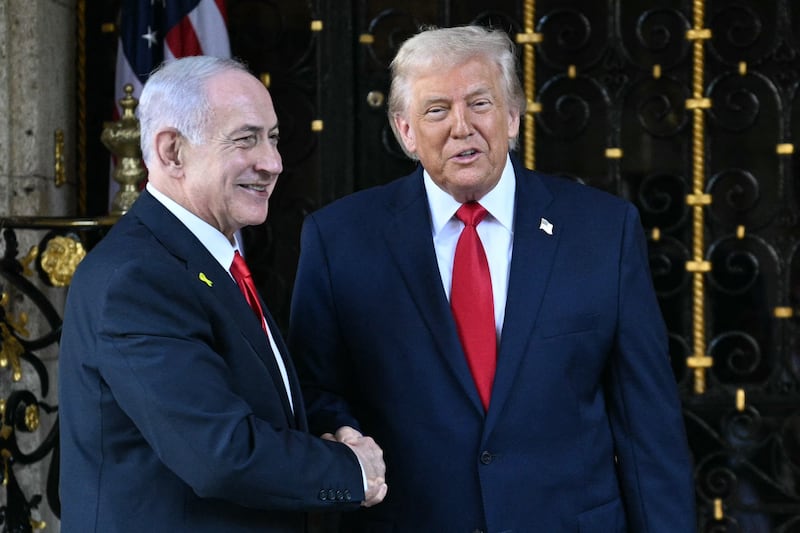 President Donald Trump (R) greets Israeli Prime Minister Benjamin Netanyahu (L) upon arrival at Trump's Mar-a-Lago residence in Palm Beach, Florida, on December 29, 2025.