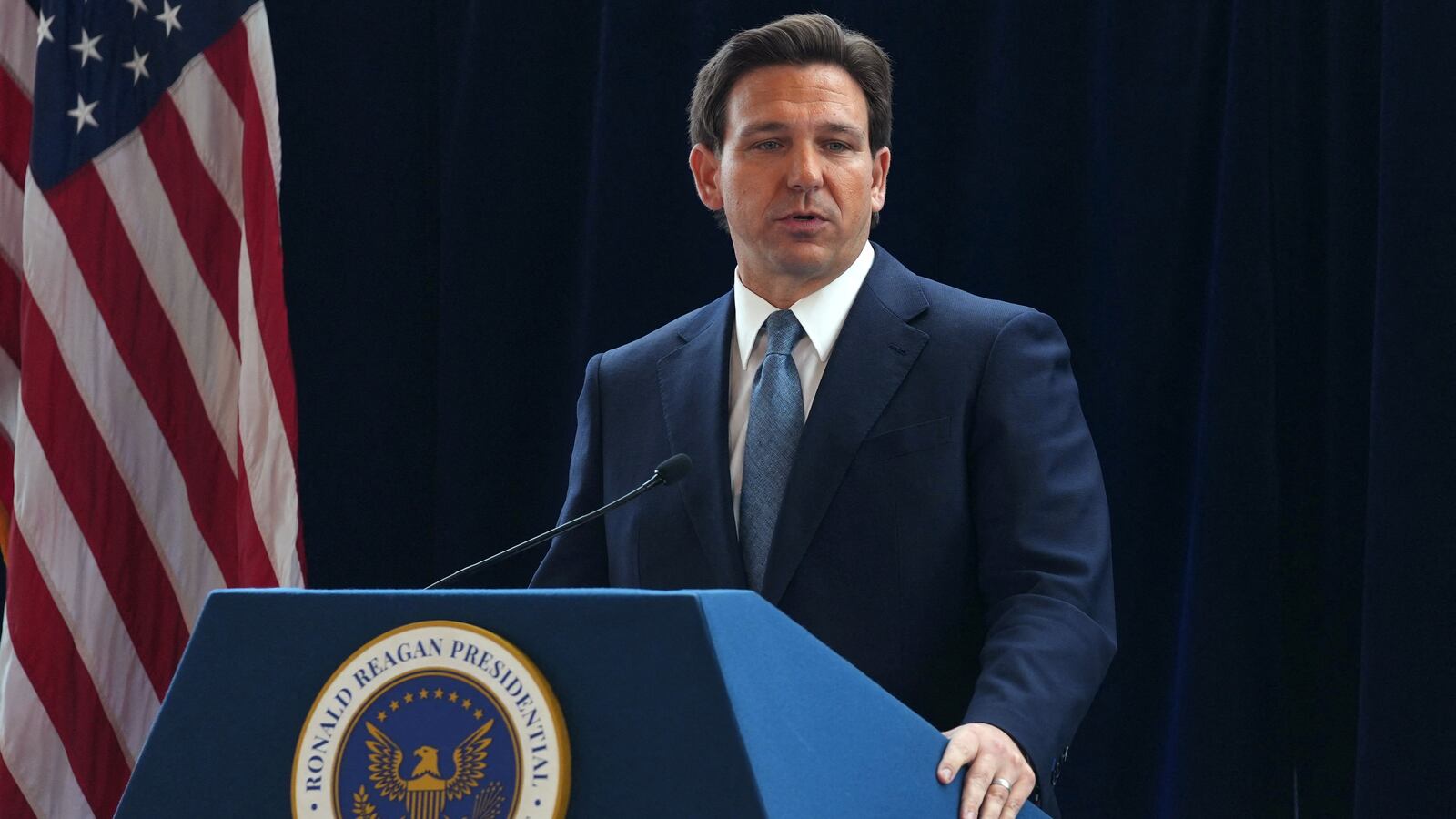 Ron DeSantis stands at a podium