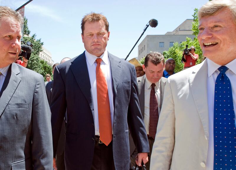 Former Major League Baseball pitcher Roger Clemens (C) leaves the federal courthouse with attorney Rusty Hardin (R) in Washington July 14, 2011. A judge declared a mistrial on Thursday in the perjury trial of baseball great Clemens, because prosecutors violated an order that barred certain information from being introduced to the jury. Clemens is facing charges that he lied to the committee when he denied taking steroids and human growth hormones from 1998 to 2001.