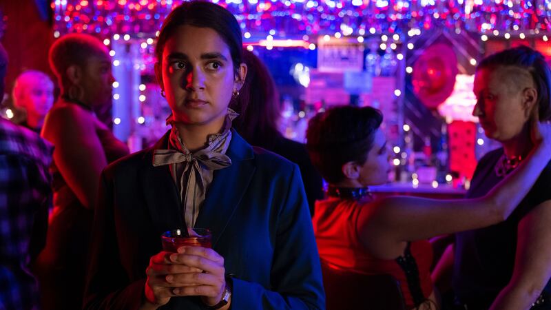 A photo including a still from the film Drive-Away Dolls