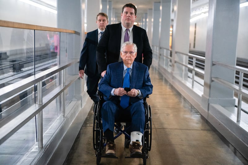 A staffer pushes U.S. Senator Mitch McConnell (R-KY) in a wheelchair at the U.S. Capitol, in Washington, D.C., U.S., March 12, 2025.