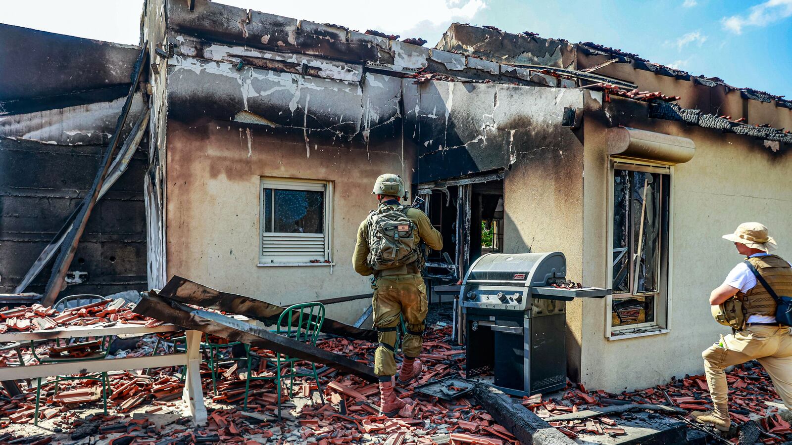Israeli forces are seen among the rubble of buildings destroyed after the clashes between Israeli and Palestinian forces in Be'eri, Israel