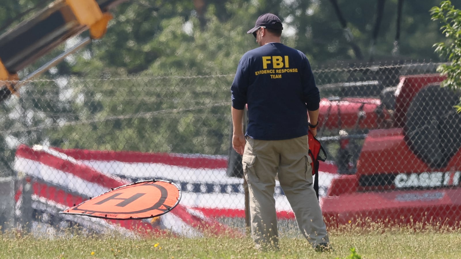 An FBI agent looks at evidence in the aftermath of the Trump rally shooting