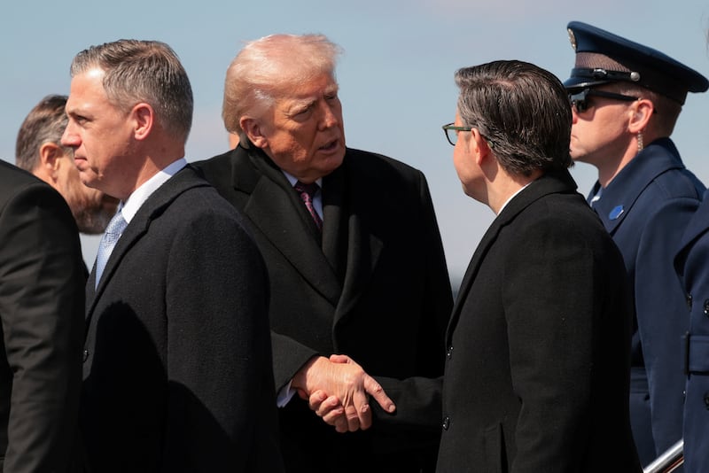 U.S. President Donald Trump shakes hands with House Speaker Mike Johnson (R-LA), at Dover Air Force Base in Dover, Delaware, U.S., March 18, 2026. REUTERS/Kylie Cooper