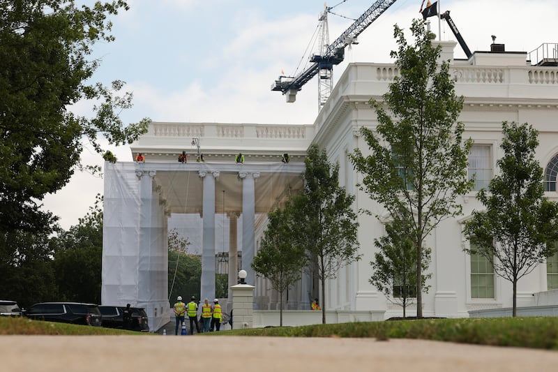 Construction workers place a tarp over the scaffolding that surrounds the columns at the North Portico of the White House on July 09, 2026 in Washington, DC.  President Donald Trump continues to do construction throughout the White House grounds.