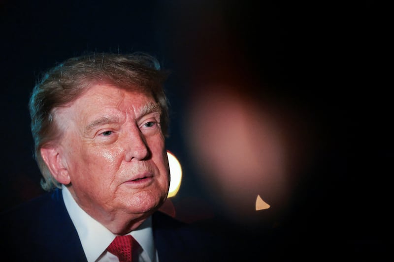 U.S. President Donald Trump looks on as he speaks to members of the media after disembarking Air Force One at Joint Base Andrews, Maryland, U.S., August 11, 2026.