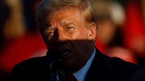 A shadow is cast across Republican presidential nominee, former President Donald Trump as he addresses a campaign rally at the Butler Farm Show grounds on October 05, 2024 in Butler, Pennsylvania.