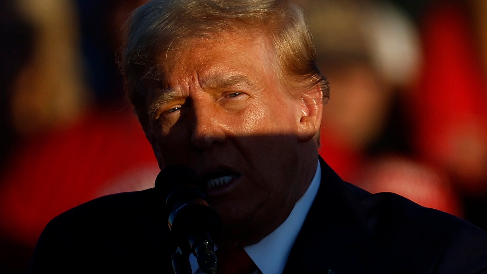 A shadow is cast across Republican presidential nominee, former President Donald Trump as he addresses a campaign rally at the Butler Farm Show grounds on October 05, 2024 in Butler, Pennsylvania.