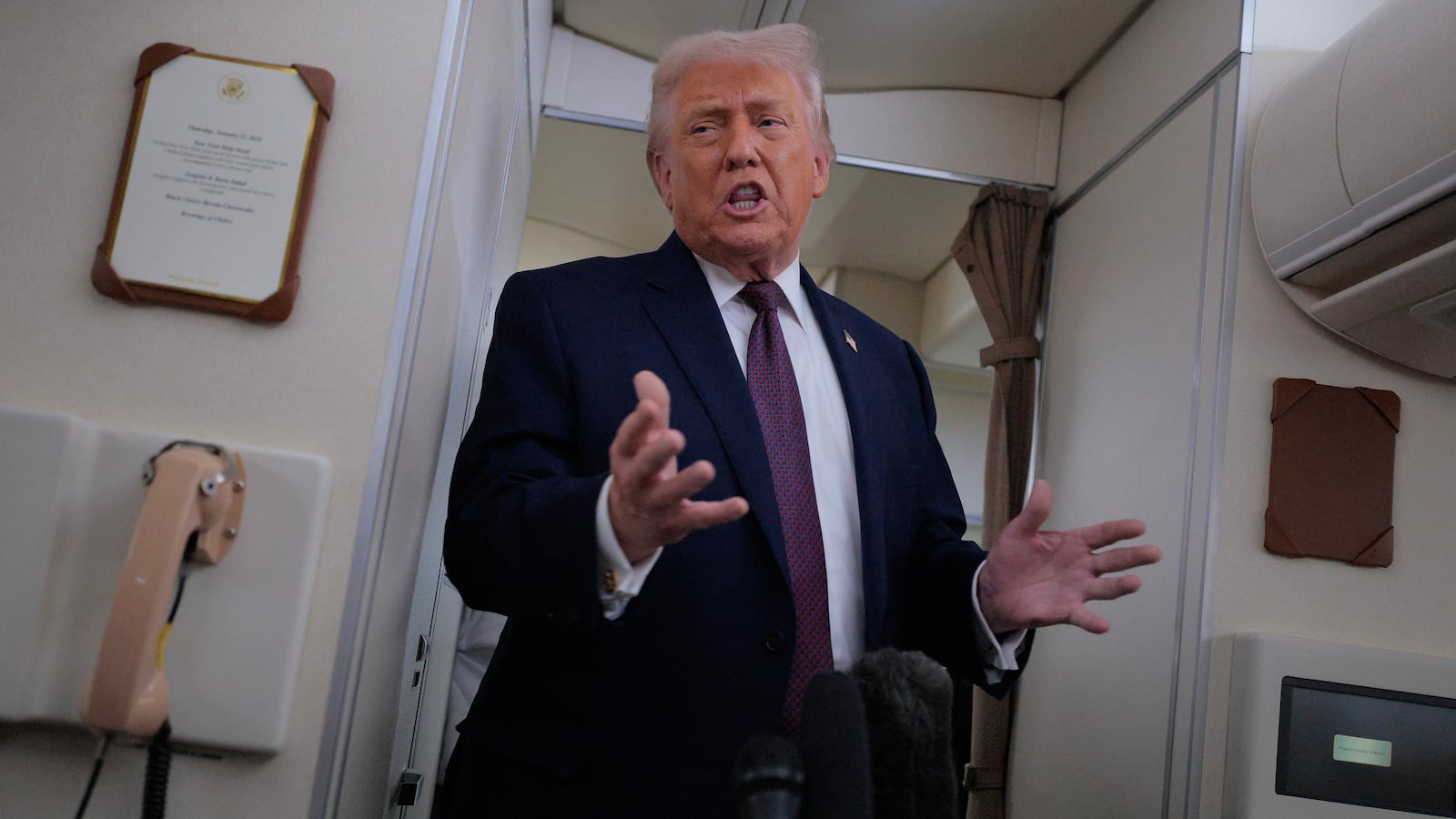 IN FLIGHT - JANUARY 22: U.S. President Donald Trump speaks to reporters on board Air Force One while flying in between Ireland and Washington as he returns from the World Economic Forum on January 22, 2026. Following a meeting with NATO Secretary General Mark Rutte, Trump announced a deal with European leaders on the semi-autonomous Danish territory of Greenland during the annual meeting of political and business leaders in Davos. (Photo by Chip Somodevilla/Getty Images)