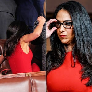 Lauren Boebert (R-CO) grabs onto a fellow member of Congress as she falls off of the seat she was standing in to watch President Donald Trump depart after a joint session of Congress at the Capitol on Feb. 24, 2026.