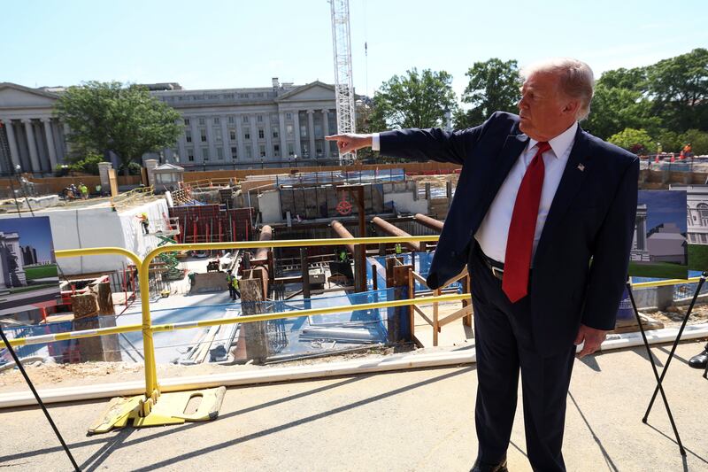 U..S. President Donald Trump points at the site of ongoing construction of the planned White House ballroom in Washington, D.C., U.S., May 19, 2026. REUTERS/Kevin Lamarque