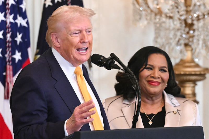 (L/R) US President Donald Trump speaks alongside Alice Marie Johnson, the "White House Pardon Czar," during a Black History Month event in the East Room of the White House in Washington, DC, on February 18, 2026. (Photo by SAUL LOEB / AFP via Getty Images)