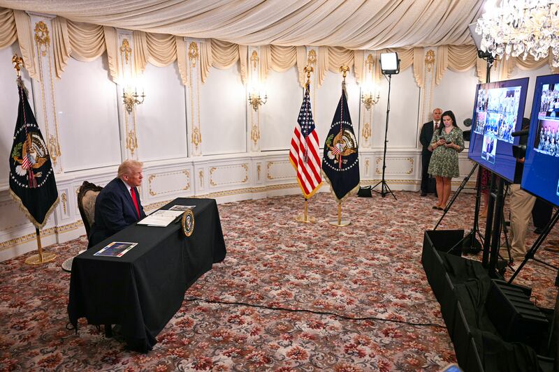 US President Donald Trump participates in a call with service members