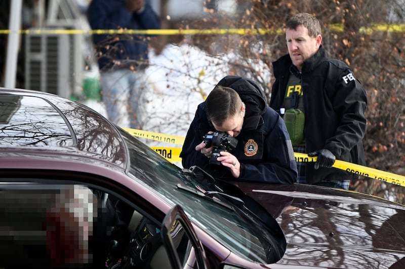 Members of law enforcement photograph a vehicle suspected to be involved in a shooting by an ICE agent during federal law enforcement operations on January 07, 2026 in Minneapolis, Minnesota. According to federal officials, the agent, “fearing for his life” killed a woman during a confrontation in south Minneapolis.