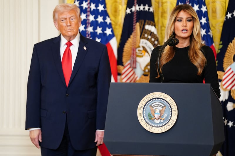 U.S. first lady Melania Trump speaks next to U.S President Donald Trump during a Women's History Month event, in the East Room of the White House in Washington, D.C., U.S. March 12, 2026. REUTERS/Nathan Howard