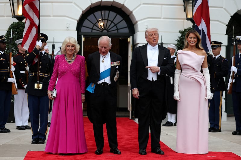 President Donald Trump points towards Britain's King Charles as they stand with first lady Melania Trump and Queen Camilla