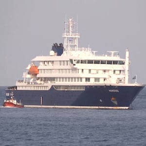 A boat beside cruise ship MV Hondius, hit by Hantavirus, anchored off Cape Verde port, on the day sick passengers were evacuated by boat from the cruise ship, in Praia Port, Cape Verde, in this screengrab obtained from a video, May 5, 2026.