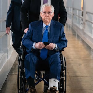 A staffer pushes U.S. Senator Mitch McConnell (R-KY) in a wheelchair at the U.S. Capitol, in Washington, D.C., U.S., March 12, 2025.