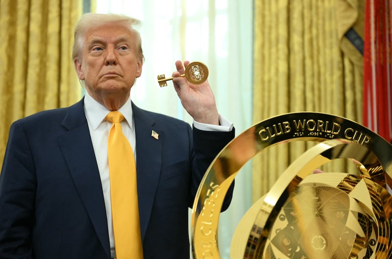 US President Donald Trump holds the key to unlock the new FIFA Club World Cup trophy in the Oval office of the White House, in Washington, DC, on March 7, 2025. (Photo by Jim WATSON / AFP) (Photo by JIM WATSON/AFP via Getty Images)