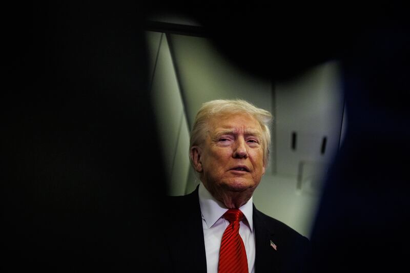 U.S. President Donald Trump speaks to reporters aboard Air Force One en route to the White House on November 2, 2025 after taking off from Palm Beach International Airport in West Palm Beach, Florida.