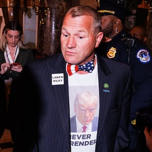 Rep. Troy Nehls walks to the House Chamber wearing a Donald Trump shirt and a Laken Riley pin ahead of the President's State of the Union address