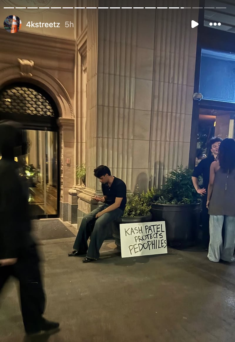 Protesters held signs calling out Patel for his handling of the "Epstein files."