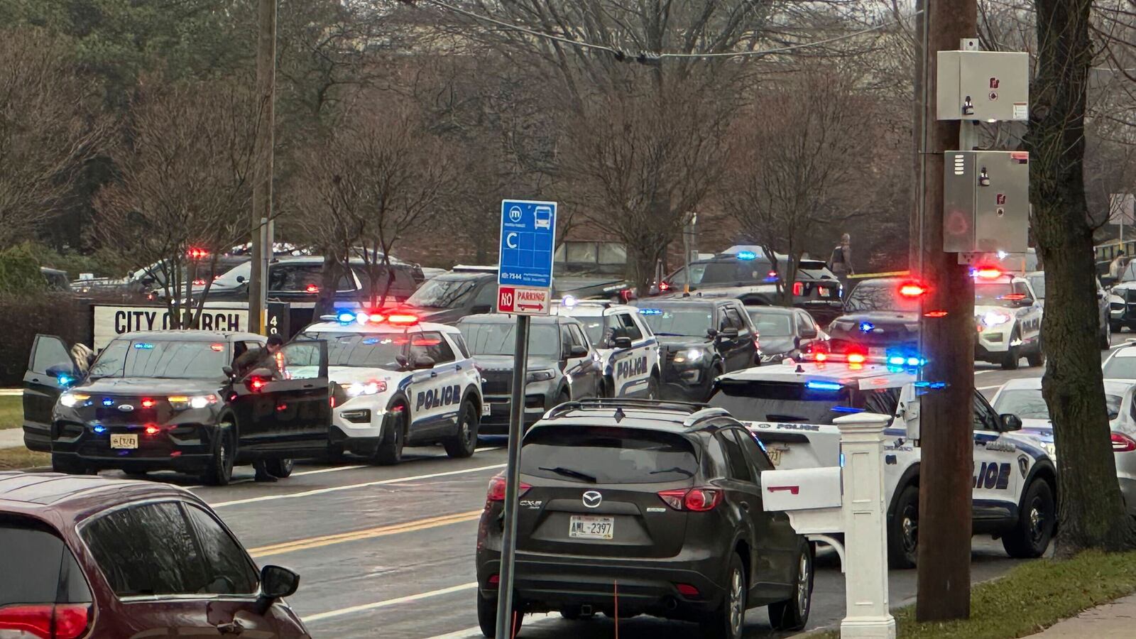 Emergency vehicles are parked outside the Abundant Life Christian School in Madison, Wis., where multiple injuries were reported following a shooting, Monday, Dec. 16, 2024. (AP Photo/Scott Bauer)