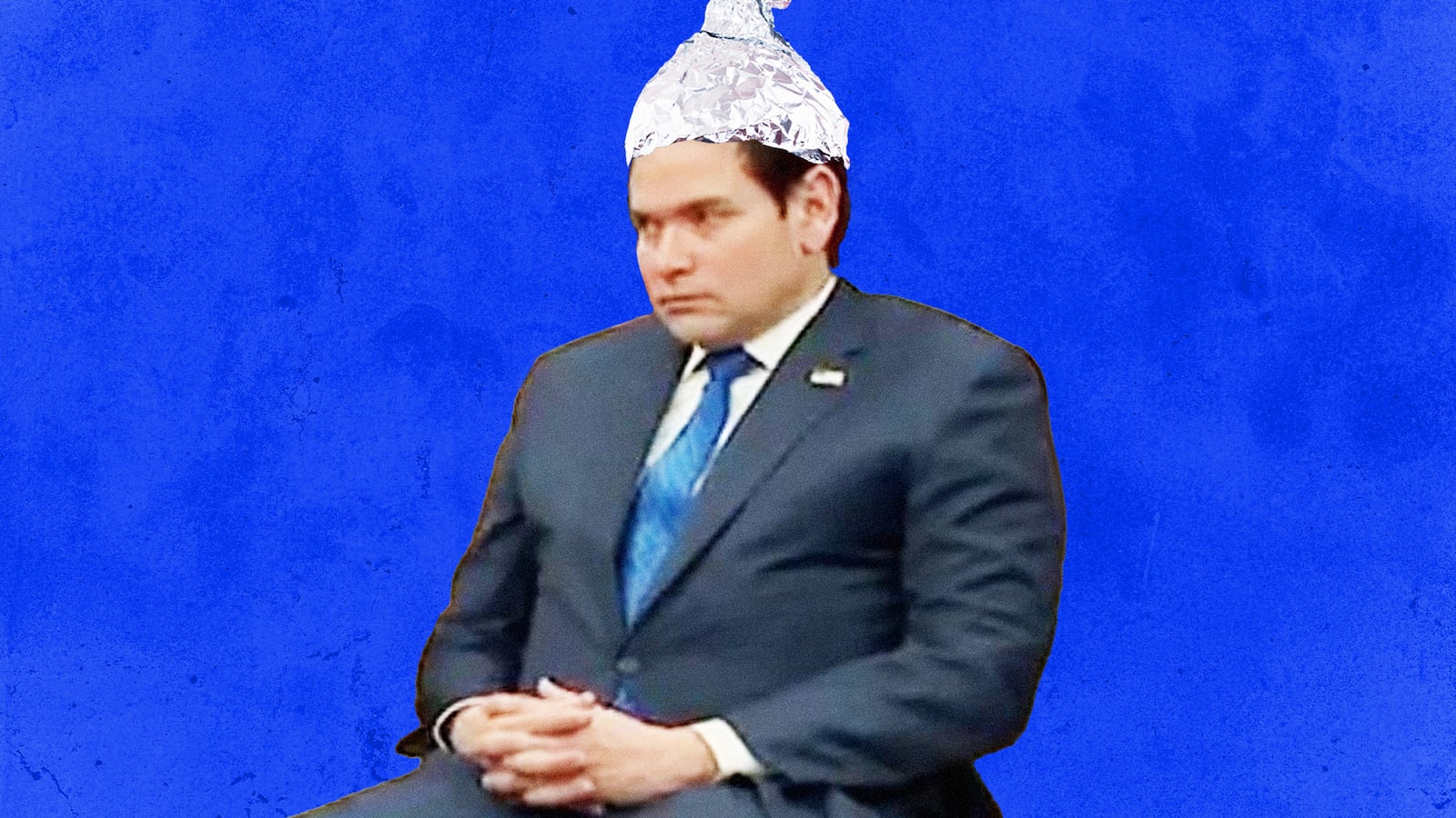A photo illustration of Marco Rubio wearing an tinfoil hat.