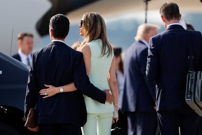 Donald Trump Jr. and Bettina Anderson stand on the tarmac as U.S. President Donald Trump arrives to board the new Air Force One, a plane gifted by the Qatari government, after departing Joint Base Andrews, Maryland, U.S., July 1, 2026. REUTERS/Kylie Cooper