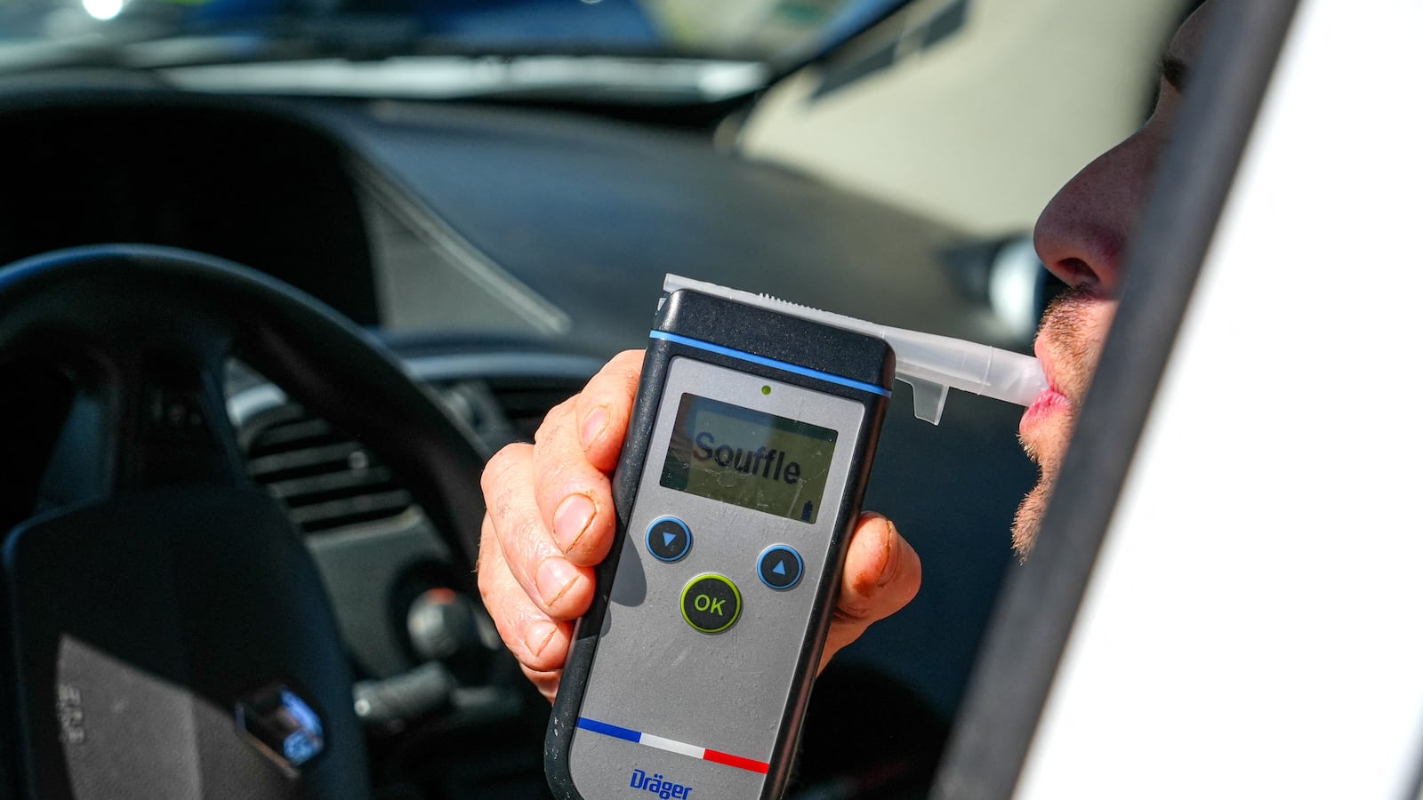 A motorist blows into a Drager Alcotest type breathalyzer as part of an alcohol test in Etoile sur Rhone, France, on April 25, 2025. The Prefect of Drome calls for the strengthening of road controls by law enforcement, including the national gendarmerie, following a sharp increase in the mortality rate on the roads. (Photo by Nicolas Guyonnet / Hans Lucas via AFP) (Photo by NICOLAS GUYONNET/Hans Lucas/AFP via Getty Images)