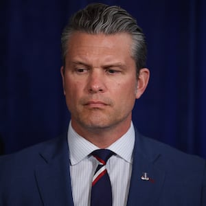 PALM BEACH, FLORIDA - JANUARY 03: U.S. Secretary of War Pete Hegseth listens as U.S. President Donald Trump addresses the media during a news conference at his Mar-a-Lago club on January 03, 2026, in Palm Beach, Florida. President Trump confirmed that the U.S. military carried out a large-scale strike in Caracas overnight, resulting in the capture of Venezuelan leader Nicolas Maduro and his wife, Cilia Flores.  (Photo by Joe Raedle/Getty Images)