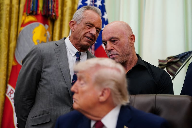 U.S. Health and Human Services (HHS) Secretary Robert F. Kennedy Jr. speaks with podcaster Joe Rogan, on the day U.S. President Donald Trump signs an executive order about easing restrictions on mental health treatments, including, ibogaine, in the Oval Office of the White House in Washington, D.C., April 18, 2026. REUTERS/Nathan Howard