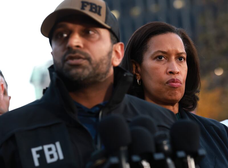 Washington, DC Mayor Muriel Bowser (R) stands near FBI Director Kash Patel