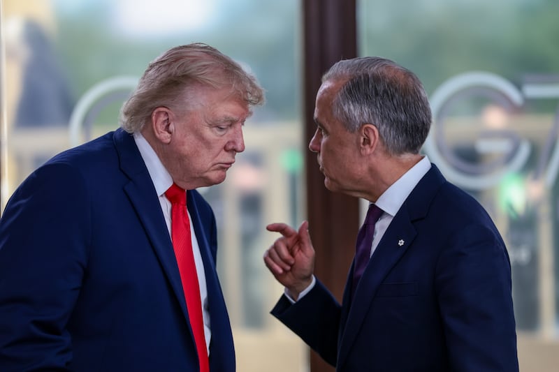 U.S. President Donald Trump speaks with Canadian Prime Minister Mark Carney