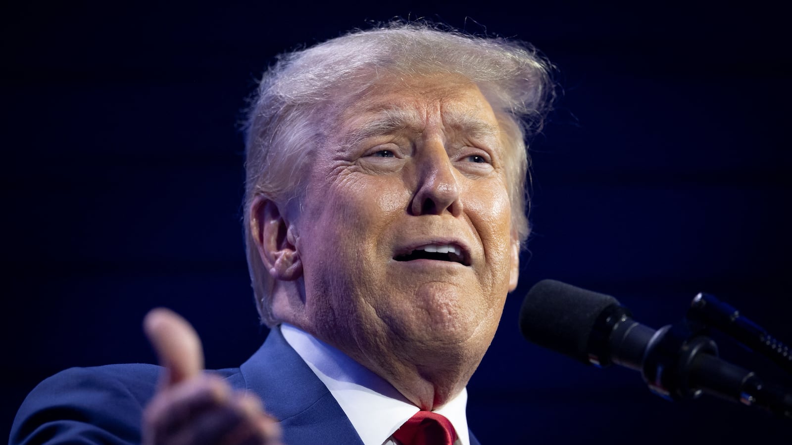 Former U.S. President and Republican presidential candidate Donald Trump gestures as he speaks during the Turning Point Action Conference in West Palm Beach, Florida