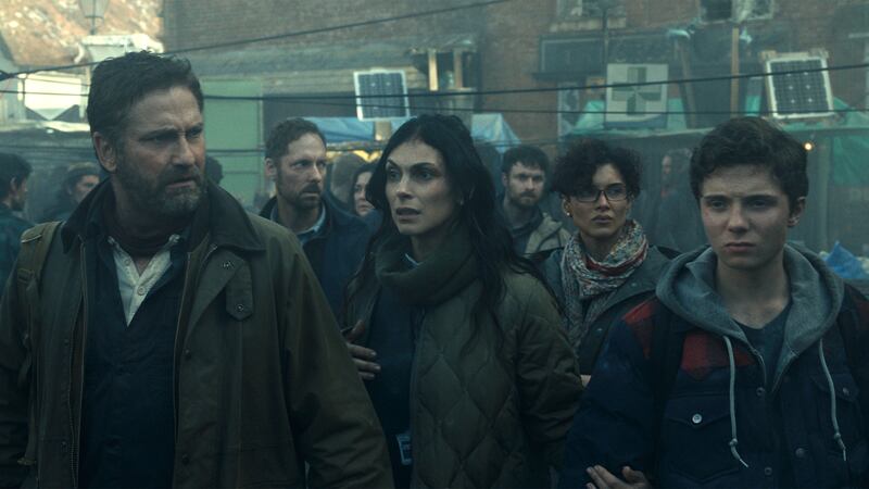 Gerard Butler as John Garrity, Morena Baccarin as Allison Garrity, Amber Rose Revah as Dr. Casey Amina, and Roman Griffin Davis as Nathan Garrity in Greenland 2: Migration.